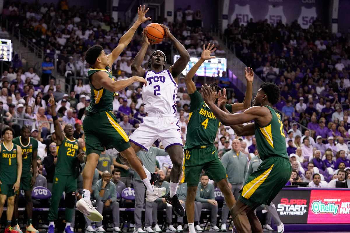 Feb 26, 2024; Fort Worth, Texas, USA; TCU Horned Frogs forward Emanuel Miller (2) drives to the basket on Baylor Bears guard RayJ Dennis (10) and guard Ja'Kobe Walter (4) during the first half at Ed and Rae Schollmaier Arena. 